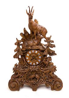 A Black Forest Carved Mantle Clock Height 28 inches.