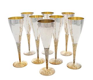 A Set of Eight English Silver Champagne Flutes, Stuart Devlin, London, 1971, each having a spot-hammered finish and a gilt stem.