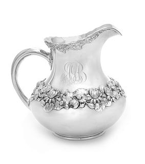 An American Silver Water Pitcher, Gorham Mfg. Co., Providence, RI, 1905, the body worked to show a lily pad and a floral band, t