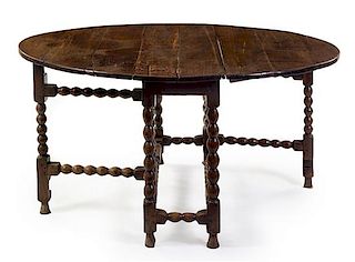 A William and Mary Oak Drop-Leaf Table Height 29 1/2 x width 46 x depth 16 inches.