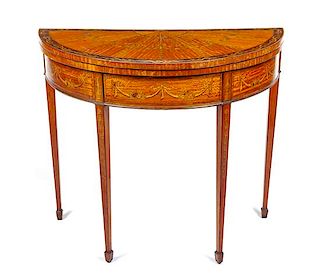 A George III Satinwood and Marquetry Flip-Top Table Height 31 1/4 x width 34 1/2 x depth 18 1/4 inches.