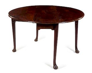 A George III Mahogany Drop-Leaf Table Height 28 x width 47 1/2 x depth 16 3/4 inches (closed).