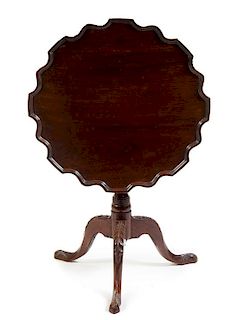 A George III Mahogany Tilt-Top Table Height 30 x diameter of top 29 1/2 inches.