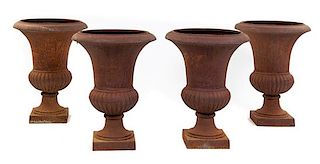 A Set of Four Victorian Cast Iron Urns Height 29 inches.