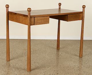 AN OAK WRITING DESK IN THE MANNER OF JEAN ROYER