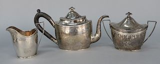 Three piece N. Harding Boston coin silver tea set including teapot, covered sugar, and creamer. 
teapot: height 6 1/4 in., 
sugar: h...