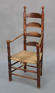 Primitive ladder back great chair with rush seat, legs ended out, late 17th to early 18th century. 
seat height 17 1/2 in., total he...