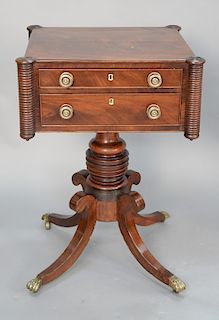 Federal mahogany two drawer work table with turret corners and two drawers, on pedestal set on four downswept members ending in bras...