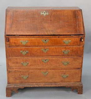 Tiger maple slant front desk on cut out bracket feet with spurs, interior with door in front of two drawers with original brasses, C...