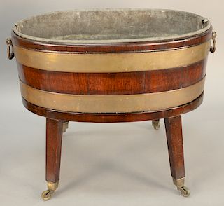 George III mahogany wine cooler, oval form with slatted sides and having a pair of carrying handles and metal liner, on square legs