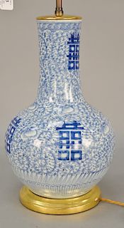 Large Chinese blue and white bottle vase having painted four character on scrolling vine and flower design, made into a table lamp. ...