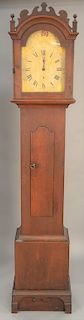Cherry tall clock with wood works and painted wood dial top with fish tail and finials, base with fish tails and bracket feet (calen...
