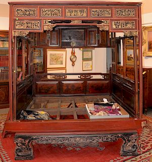 Chinese wedding bed having pierced carved panels and painted panels doors and drawers. 
height 93 in., width 85 1/2 in., depth 70 in.
