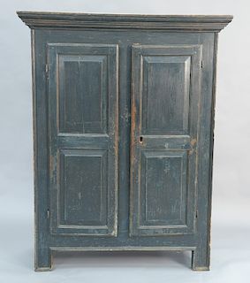 Primitive cupboard having two raised panel doors and a molded surround. 
height 68 in., width 47 in.