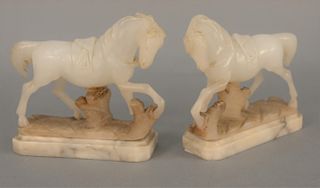 Pair of large white hardstone horses on marble bases. 
height 7 1/2 in., length 8 1/2 in.