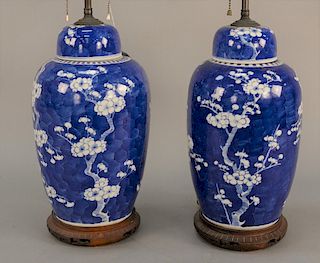 Pair of Chinese blue and white covered jars with apple blossoms, now made into table lamps. 
jar height 14 1/2 inches, 28 inches to ...
