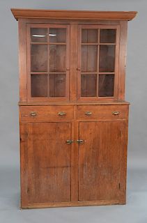 Primitive stepback cupboard having two glass doors over two drawers over two doors (top doors are replaced). 
height 78 3/4 in., wid...
