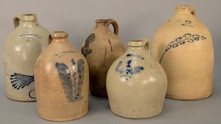 Group of five stoneware jugs, Whites Utica two gallon jug with blue painted bird; J. Fish Lyon's New York two gallon jug; along with...