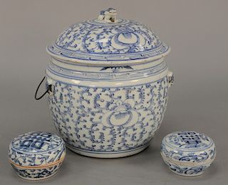 Three piece blue and white Chinese porcelain group to include two covered jars and a covered pot with foo dog handle. 
jars: height ...