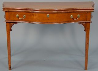 Federal cherry game table with serpentine top over conforming drawer with carved supports set on square tapered legs, circa 1790. 
h...