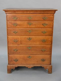 Cherry Chippendale tall chest with large cornice molded top over six drawers set on high bracket base with spurs and drop center, or...