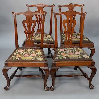 Set of four walnut side chairs with pierced vase shaped splats set on cabriole legs ending in pad feet and having block and turned s...