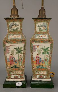 Pair of rose medallion vases made into table lamps with recessed panels having raised figures, vases, and flowers with painted bats ...