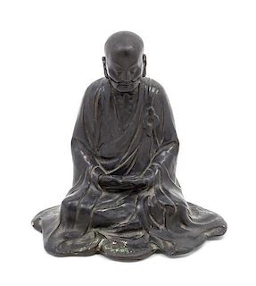* A Bronze Figure of a Luohan Height 8 x width 7 3/4 inches.