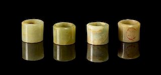 * A Group of Four Jade Archer's Rings Diameter of widest 1 1/8 inches.
