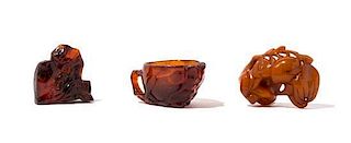* Three Carved Amber Articles Width of widest 2 3/4 inches.