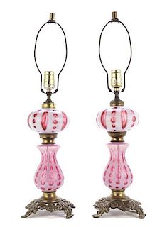 A Pair of Victorian Cranberry and White Glass Oil Lamps, Height 24 1/2 inches.