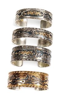 Four Southwestern Silver Storyteller Bracelets Length of one 6 x opening 7/8 x width 5/8 inches