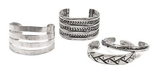 Four Southwestern Style Silver Cuff Bracelets Length of one 5 1/2 x opening 1 1/2 x width 1 5/8 inches