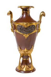 An Art Nouveau Gilt and Silvered Bronze Mounted Copper Urn Height 29 1/2 inches.