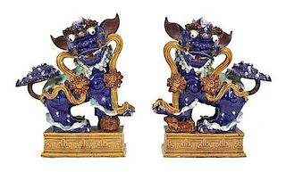 A Pair of Chinese Glazed Pottery Figures of Temple Lions. Height 29 inches.