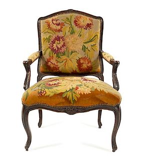 A Louis XV Style Walnut Fauteuil Height 36 inches.