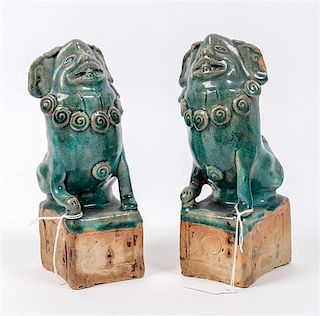 A Pair of Pottery Fu Dogs Height 8 1/4 inches overall.