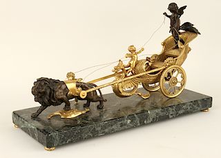 BRONZE FIGURAL GROUP OF PUTTO RIDING CHARIOT LION