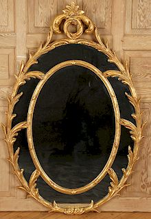 LARGE OVAL GILT MIRROR WITH FOLIATE DECORATION