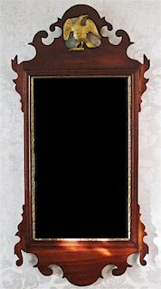 A Chippendale Parcel Gilt Mahogany Scroll Mirror, Height 35 x width 17 inches.
