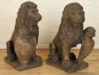 PAIR OF OPPOSING STONE SEATED LIONS