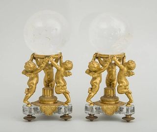 PAIR OF LOUIS XVI STYLE CHERUB-FORM STANDS AND A PAIR OF ROCK CRYSTAL SPHERES