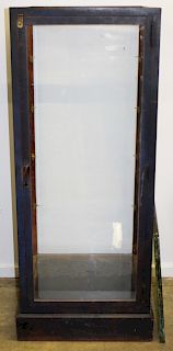 upright store display case in old blue paint