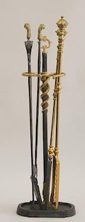 GROUP OF FOUR BRASS-HANDLED FIRE TOOLS AND A STAND