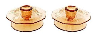 A Pair of Etched Amber Glass Candlesticks, Height 2 1/2 x diameter 5 inches.
