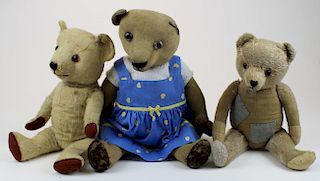 three very old well worn teddy bears