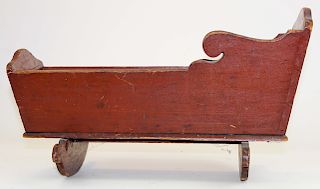 early 19th c wooden doll cradle in red paint
