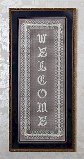 A Framed Lace Welcome Sign, Height 34 1/4 x width 16 inches.
