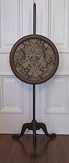 A Victorian Mahogany and Needlework Pole Screen, Height 54 3/4 x diameter 18 inches.