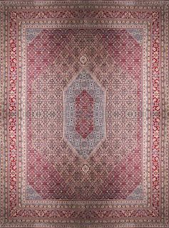 A Tabriz Wool Rug, 15 feet x 11 feet 7 inches.
